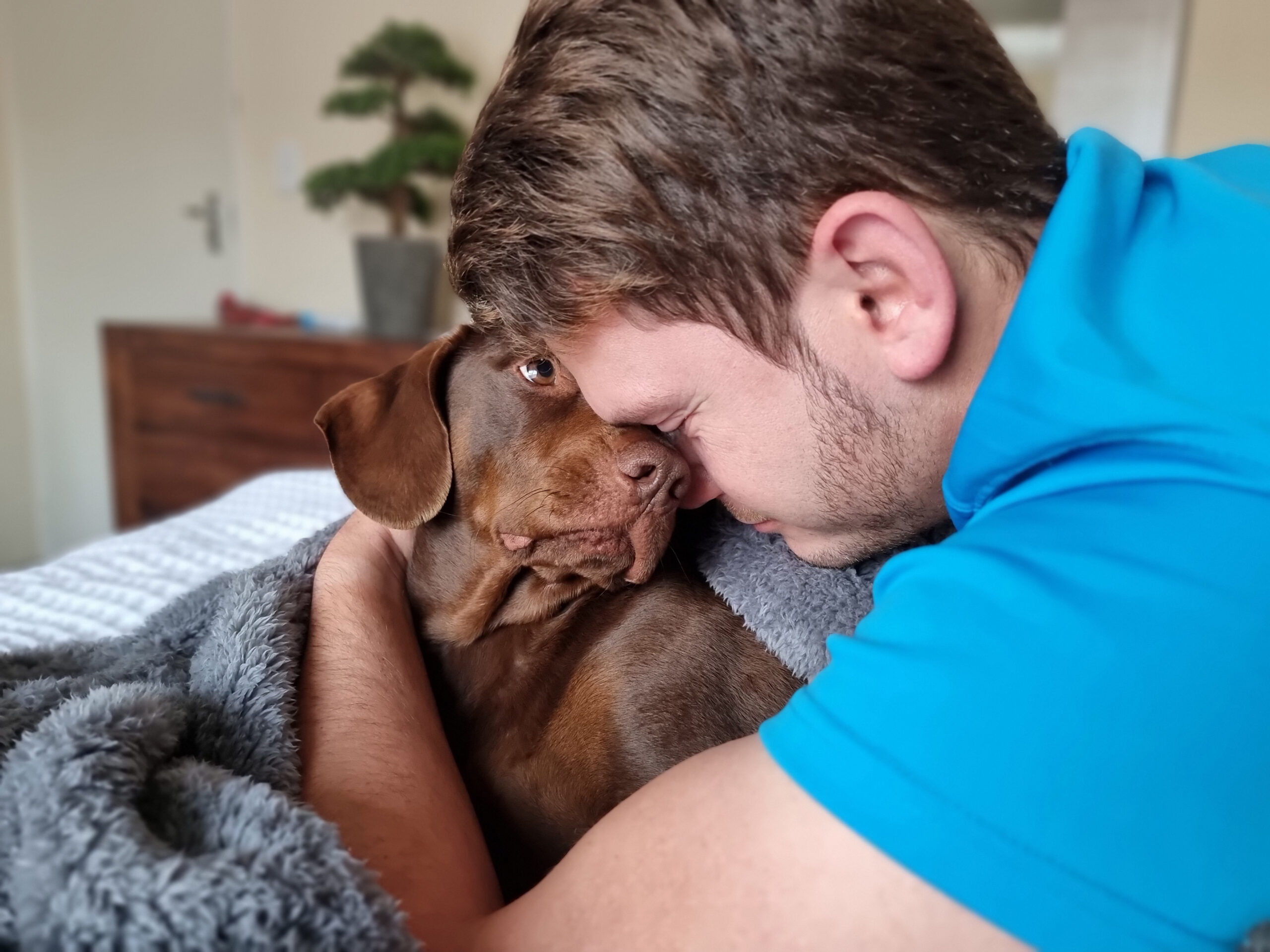 Who Qualifies for an ESA? A man hugging his ESA dog.